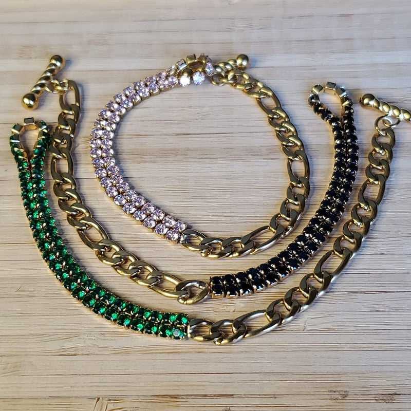 Colorful Stone Bracelet in Gold finish, with cubic zirconia stone on a wooden surface