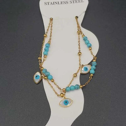 Evil Eye Anklet in Gold finish, with turquoise stone on a neutral background