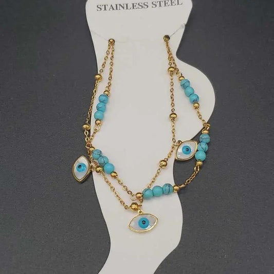 Evil Eye Anklet in Gold finish, with turquoise stone on a neutral background