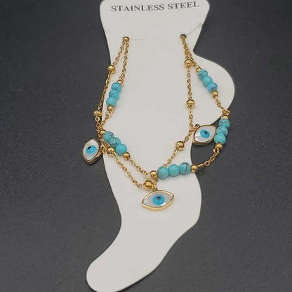 Evil Eye Anklet in Gold finish, with turquoise stone on a neutral background