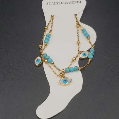 Evil Eye Anklet in Gold finish, with turquoise stone on a neutral background