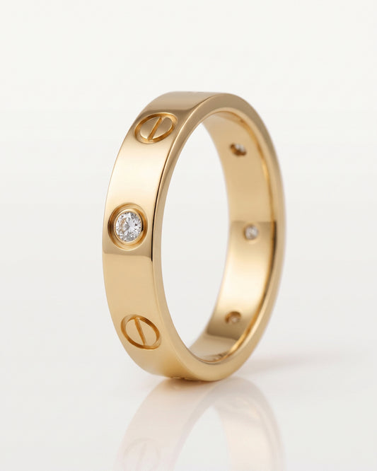 A rose gold ring with a screw motif and small clear gemstones, photographed on a clean white background.