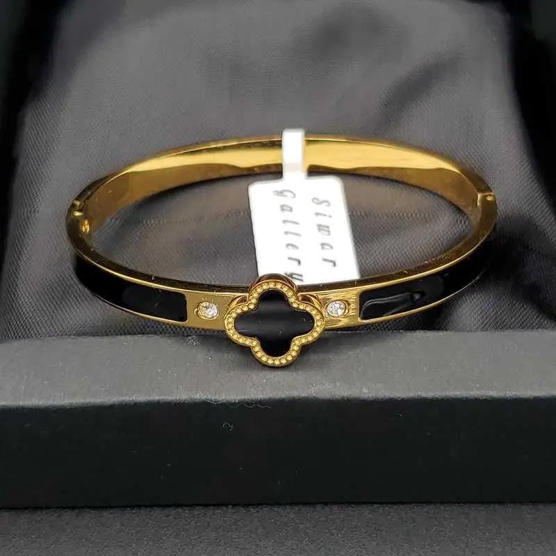 Graceful Clover Bangles in Gold finish on a neutral background