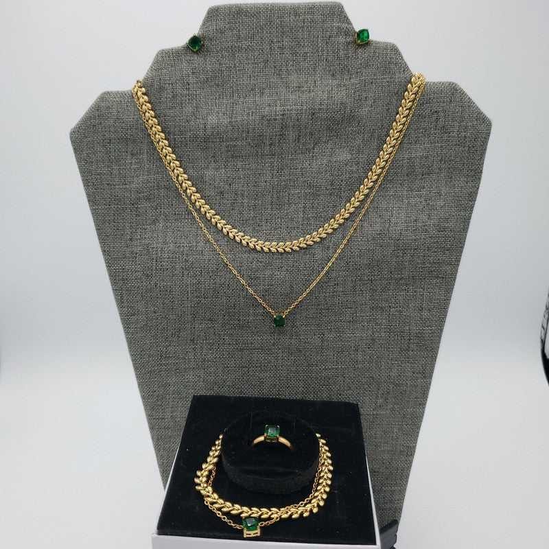 Green Stone Jewelry Sets in Gold finish on a neutral background