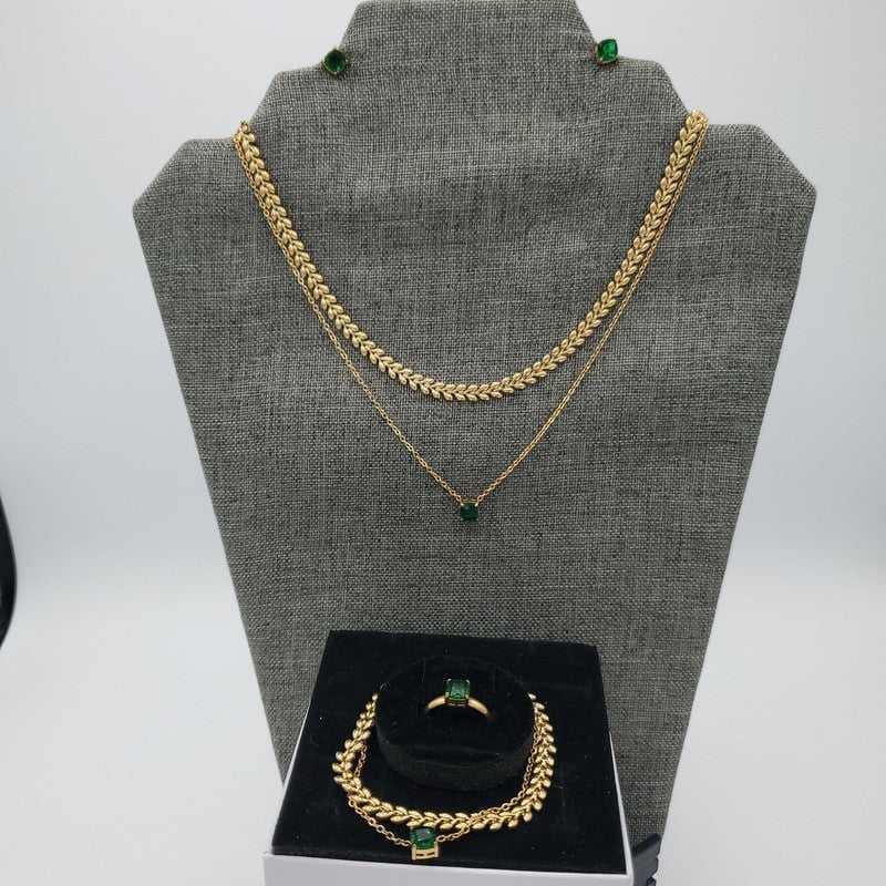 Green Stone Jewelry Sets in Gold finish on a neutral background