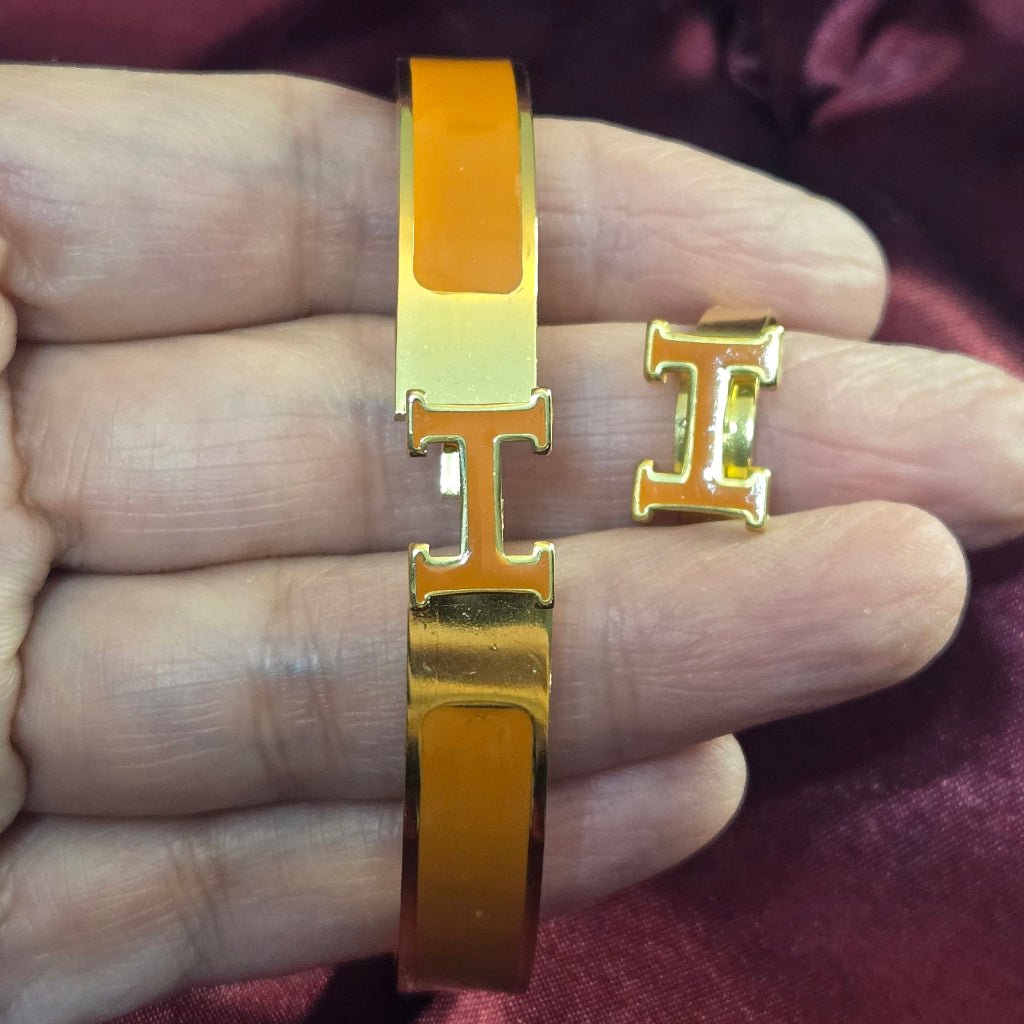 H-Signature Bangle Set in Gold finish on a neutral background