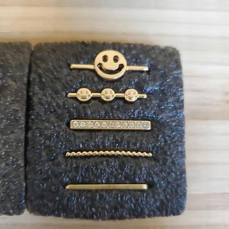 Happy Face Charms Set in Gold finish, with cubic zirconia stone on a neutral background