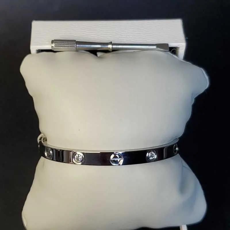 Love Screw Bangle in Silver finish, with cubic zirconia stone on stones and a screwdriver accessory