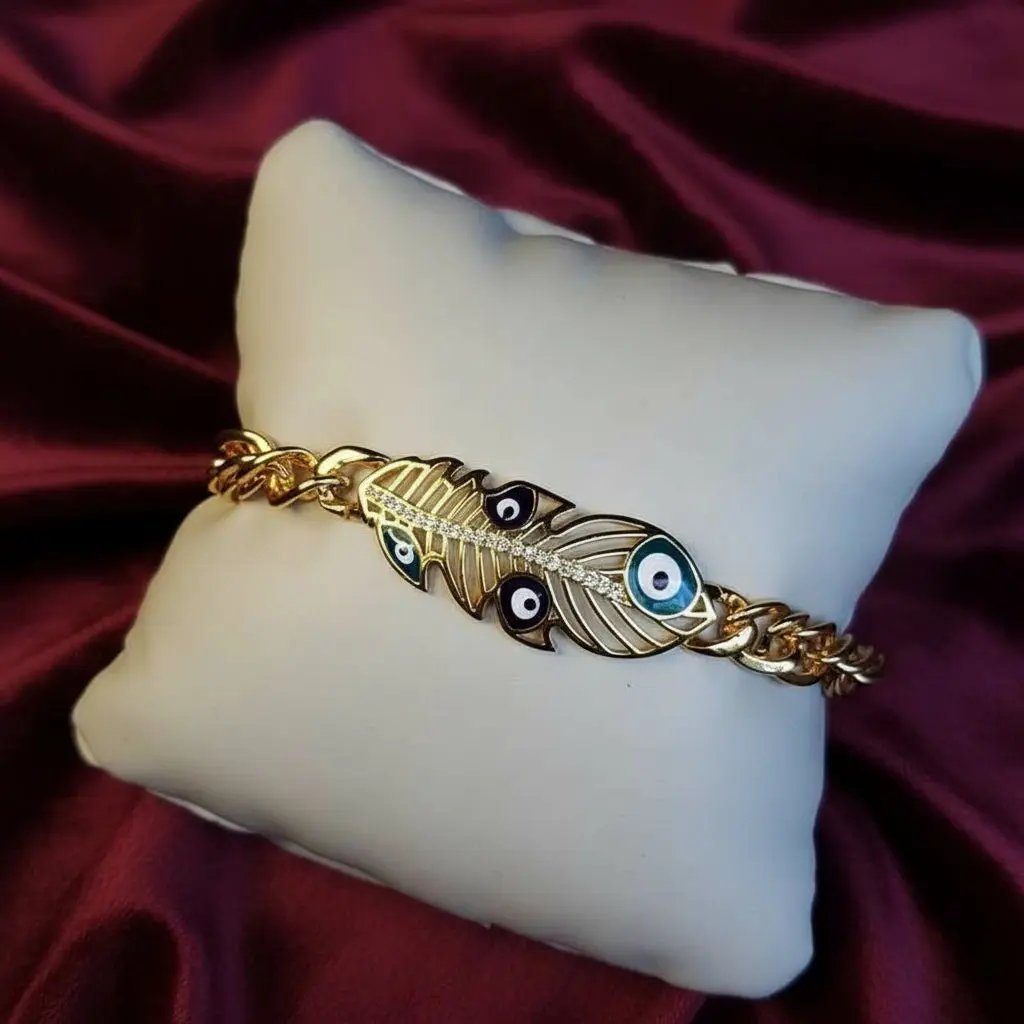 Lustrous Feather Bracelet in Gold finish, with cubic zirconia stone on stones and blue evil eye enamel details
