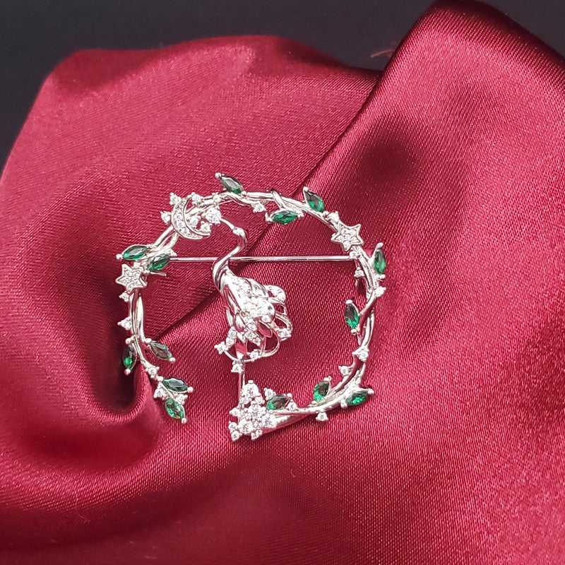Lustrous Flamingo Brooch in Silver finish, with cubic zirconia stone on stones on a leaf and star wreath pattern