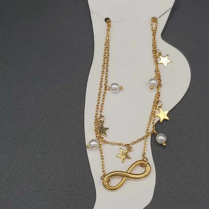 Minimalist Infinity Anklet in Gold finish, with pearl stone on a neutral background