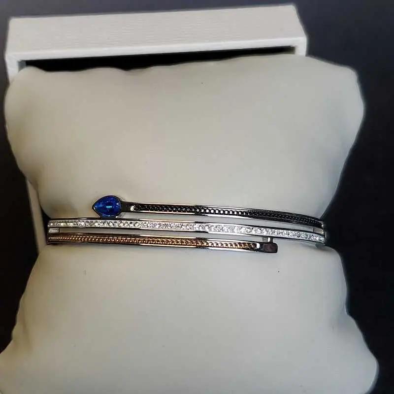 Modern Blue Teardrop Stone Bangle in Gold and Silver finish, with cubic zirconia stone on accents