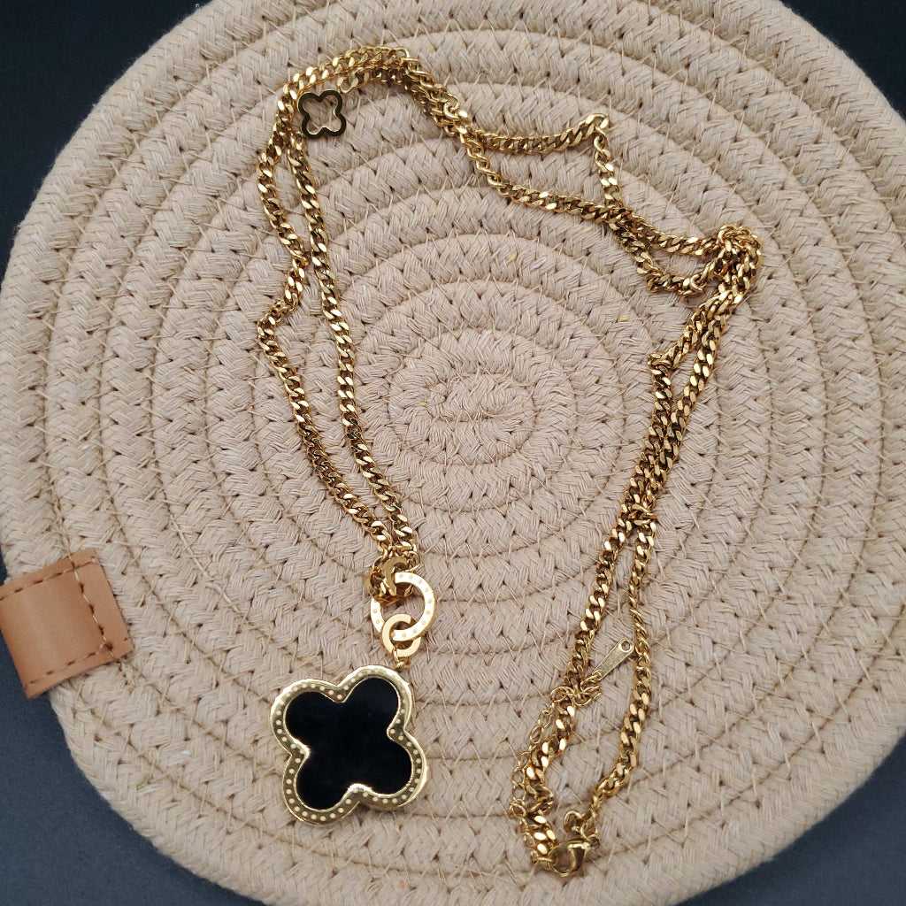 Modern Clover Necklace in Gold finish, with pearl stone on a neutral background
