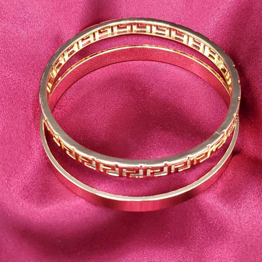 Modern Greek Key Bangle in Gold finish on a neutral background
