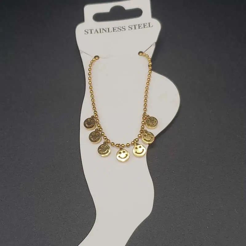 Modern Happy Face Anklet in Gold finish on a neutral background