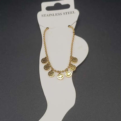 Modern Happy Face Anklet in Gold finish on a neutral background