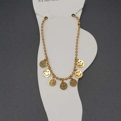 Modern Happy Face Anklet in Gold finish on a neutral background