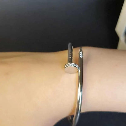 Modern Stones Nail Bangle in Silver finish, with cubic zirconia stone on stones on a wrist