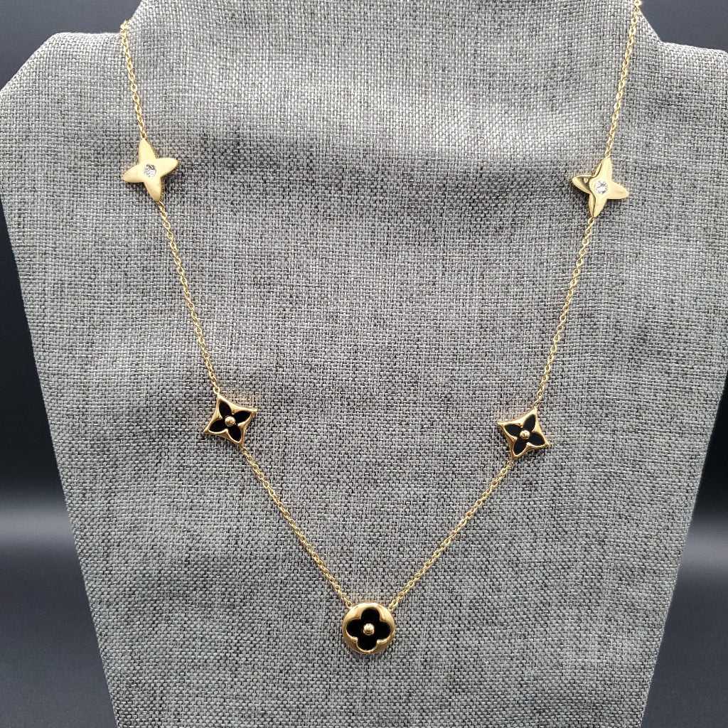 Monogram Flower Pendant Necklace in Gold finish, with cubic zirconia stone on a neutral background