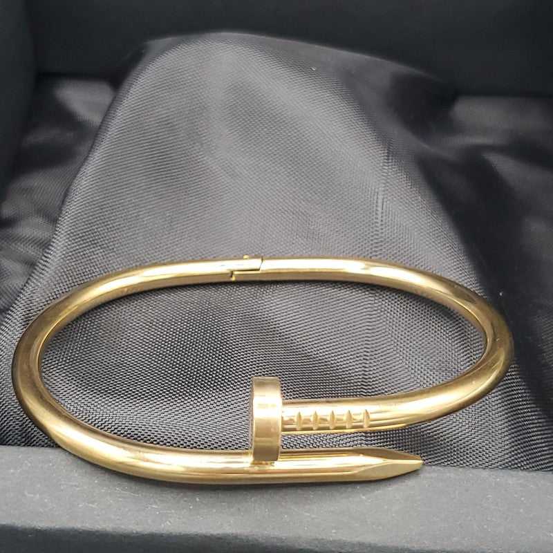 Plain Nail Bangle in Silver finish on a neutral background