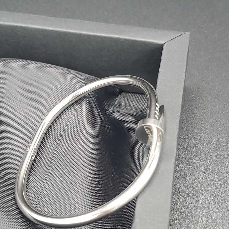 Plain Nail Bangle in Silver finish on a neutral background
