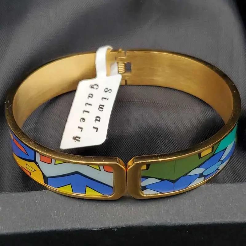 Radiant Colorful Bangle in Gold finish on a neutral background