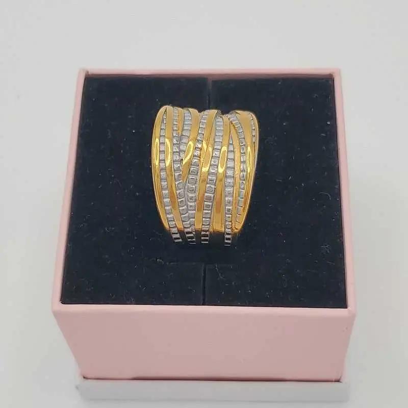 Refined Wide Ring in Gold and Silver finish, with cubic zirconia stone on a neutral background
