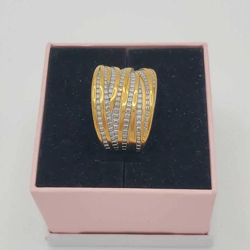 Refined Wide Ring in Gold and Silver finish, with cubic zirconia stone on a neutral background