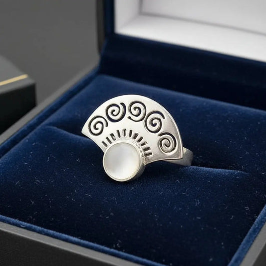 Seashell Fan Ring in Silver finish, with pearl stone on a neutral background
