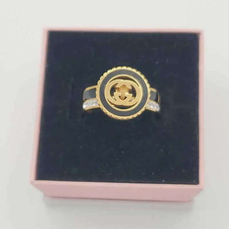 Signature Design Ring in Gold finish, with cubic zirconia stone on stones on the band
