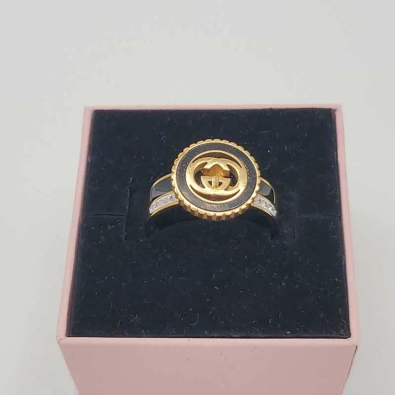 Signature Design Ring in Gold finish, with cubic zirconia stone on stones on the band