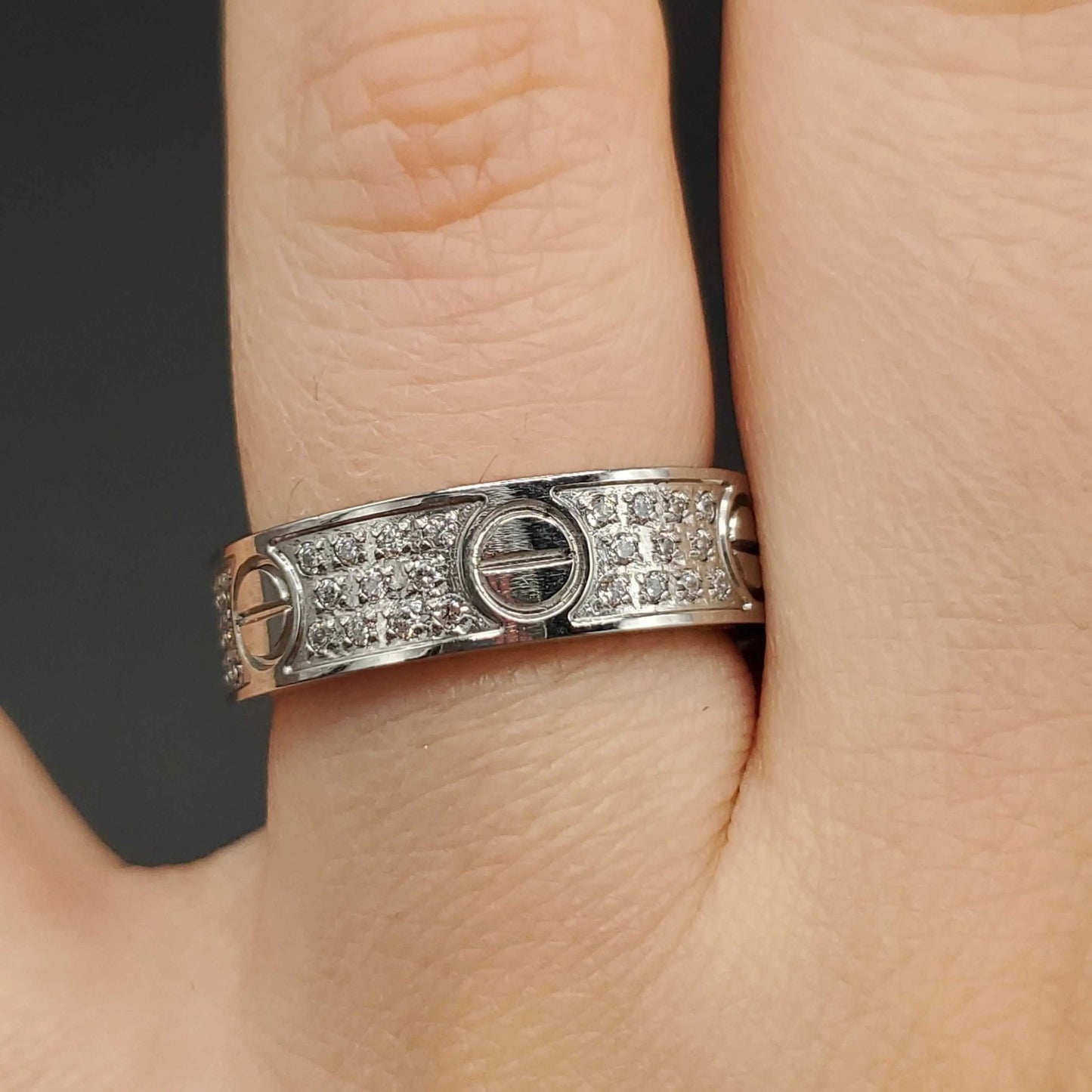 Silver Screw Ring in Silver finish, with cubic zirconia stone on stones and decorative screw motifs on a finger