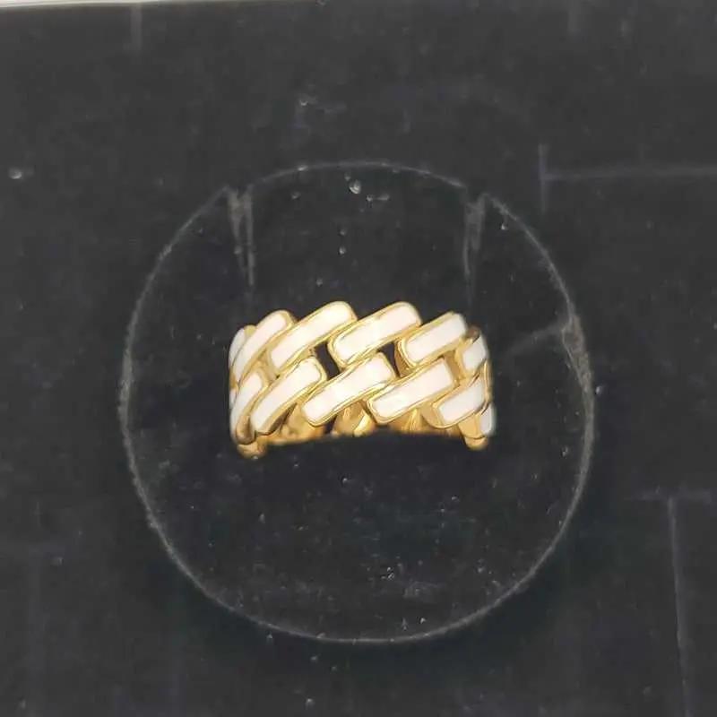 Sophisticated Enamel Ring in Gold finish on a neutral background
