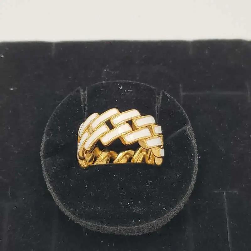 Sophisticated Enamel Ring in Gold finish on a neutral background