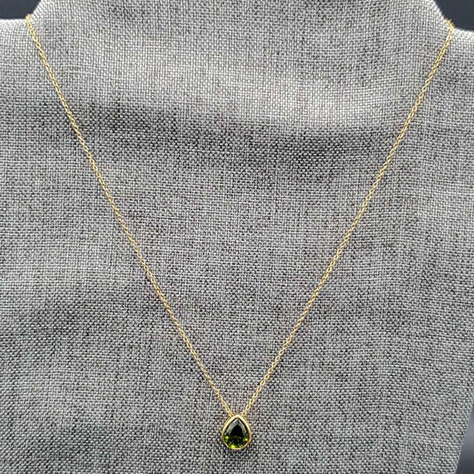 Teardrop Stone Necklace in Gold finish on a neutral background