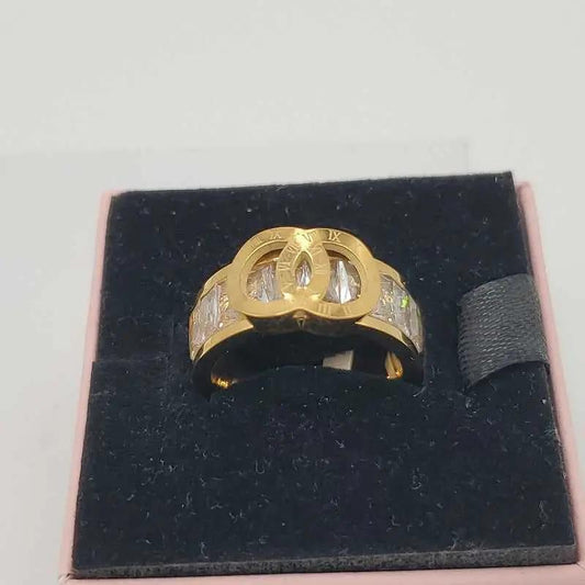 Timeless Ring in Gold finish, with cubic zirconia stone on a neutral background