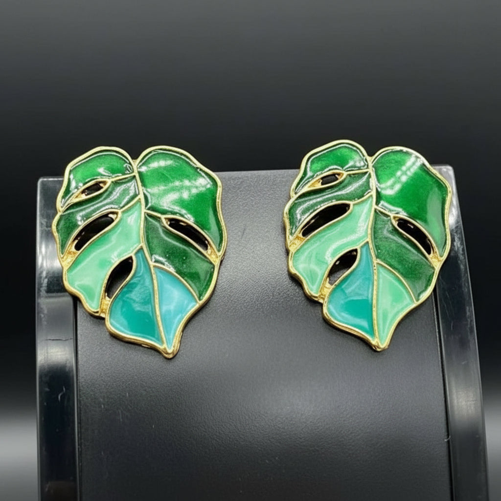 Tree Leaf Earrings in Gold finish on a neutral background