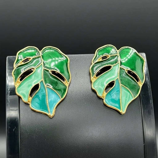 Tree Leaf Earrings in Gold finish on a neutral background